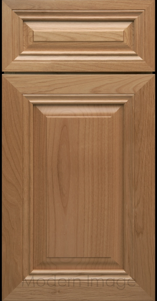 Close-up of a Honey-stained wood cabinet door with a mitered frame and traditional Cambridge raised center panel.